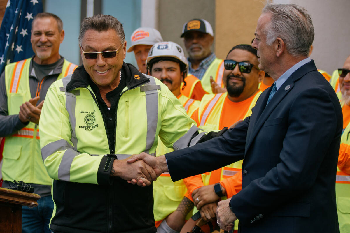 Tommy White, Business Manager and Secretary Treasurer of Local 872, shakes hands with Nevada Go ...