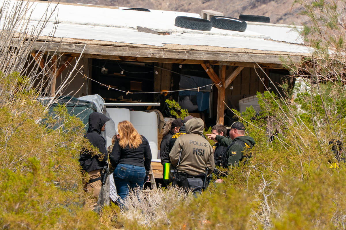 Law enforcement and animal control officers gather as un-permitted tigers are removed from a pr ...