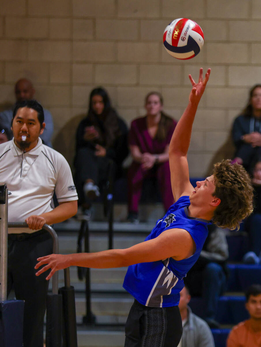 Basic Porter Hughes (5) reaches up to tip the ball over the net during the volleyball game agai ...