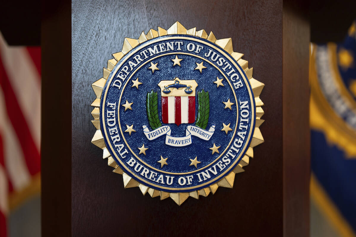 An FBI seal is displayed on a podium before a news conference at the field office in Portland, ...