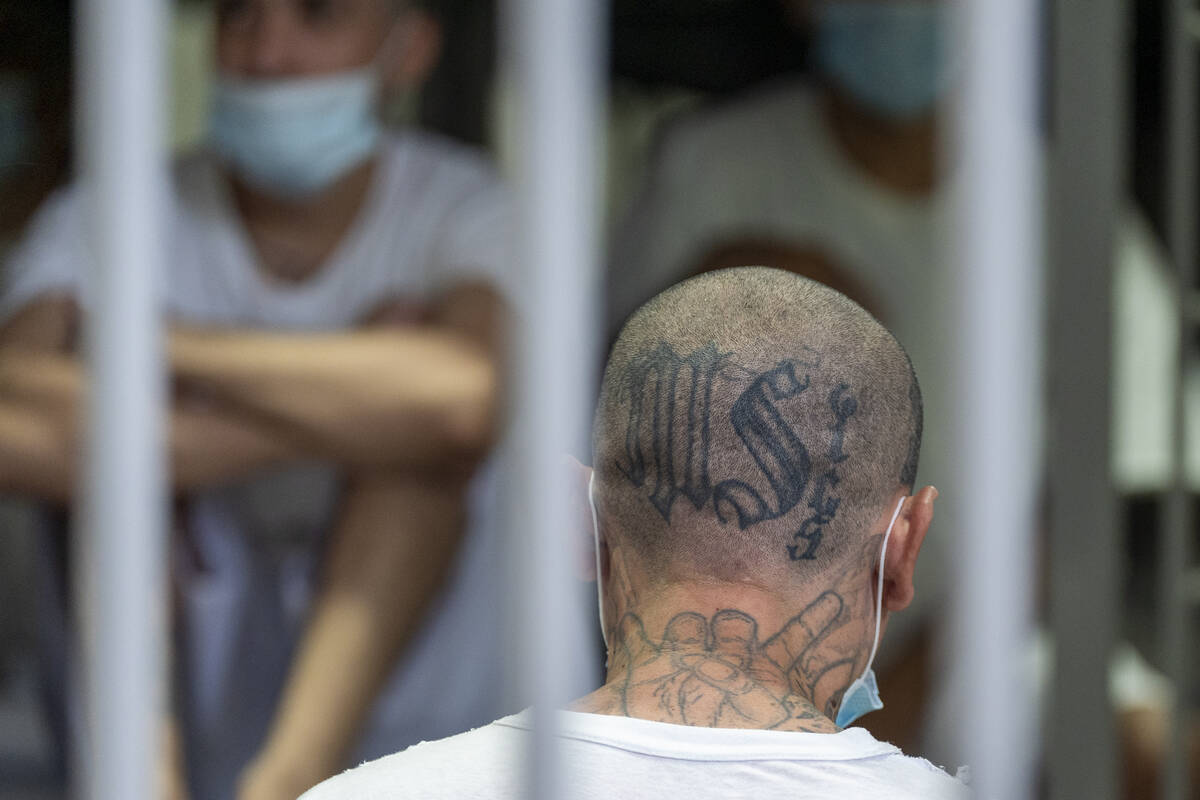 A prisoner with MS-13 gang tattoos stands in his cell as Homeland Security Secretary Kristi Noe ...