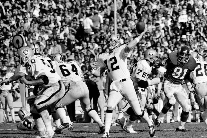 Quarterback Ken Stabler (12) of the Oakland Raiders gets off his pass behind perfect protection ...