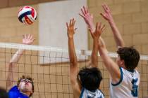 Basic outside hitter Ethan Hunt (15) takes a swing against Somerset Sky Pointe blockers Antonio ...