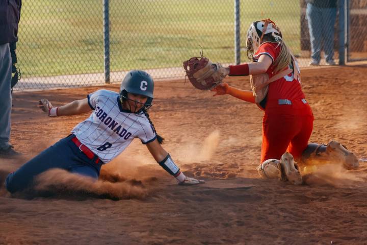 Coronado runner Alohi Mundon (8) slides safely into home plate before Arbor View catcher Kelsie ...