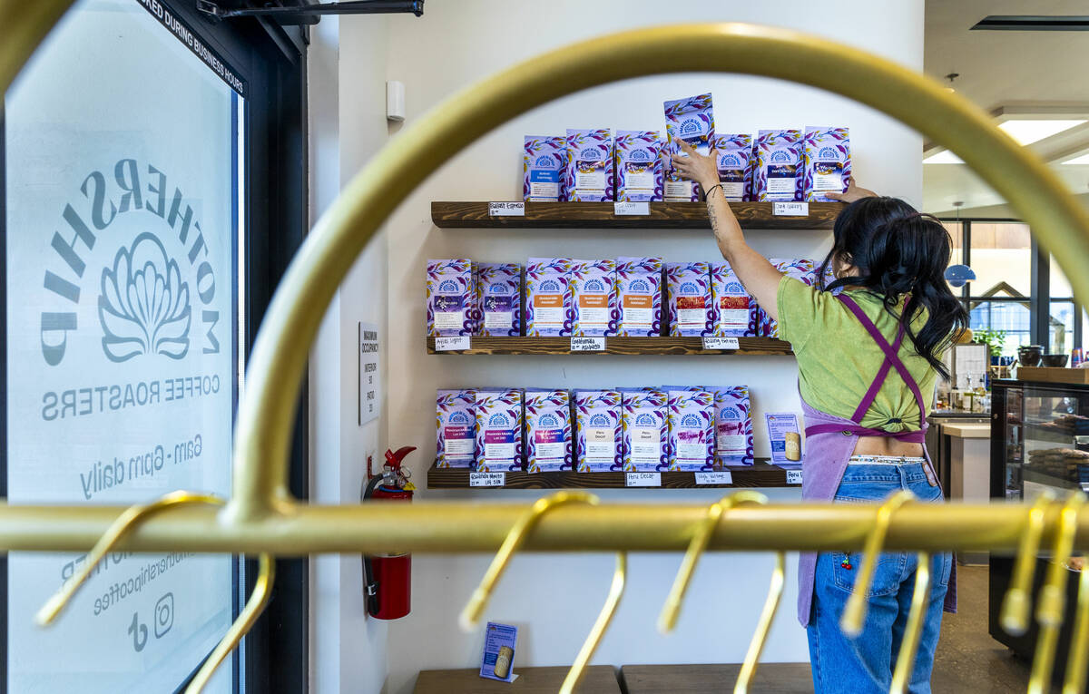 Cafe manager Sevonna Lathormvang restocks bags of coffee for sale at Mothership Coffee Roasters ...