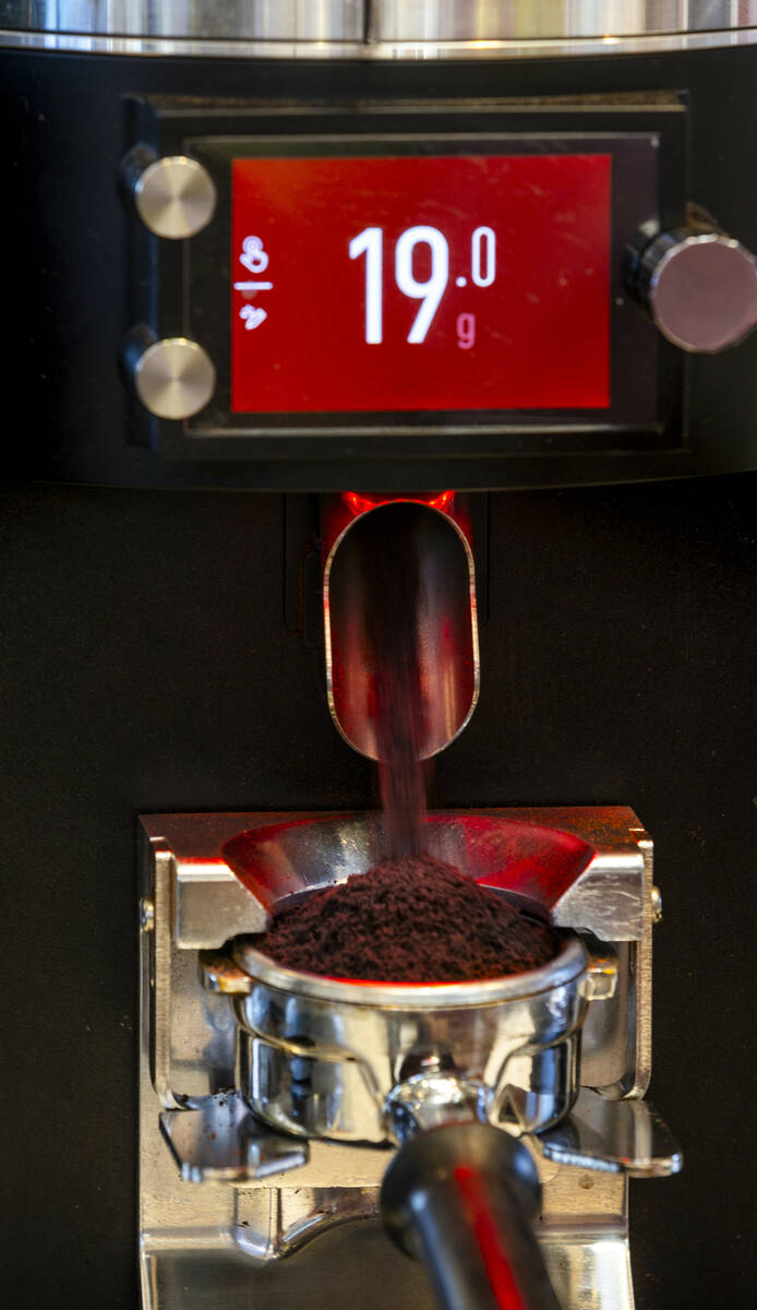 Coffee beans are ground for espresso at Mothership Coffee Roasters as they are currently absorb ...