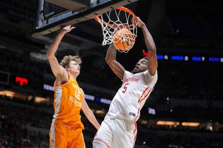 Houston's Ja'Vier Francis (5) dunks as Houston's Jacob McFarland (12) defends during the first ...