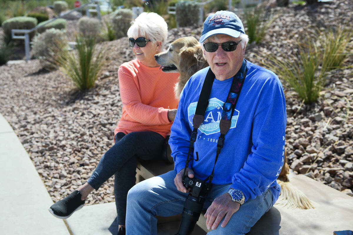 Kay and Bob Arter, with their dog Sunset, talk about the goldfish that were released in a pond ...