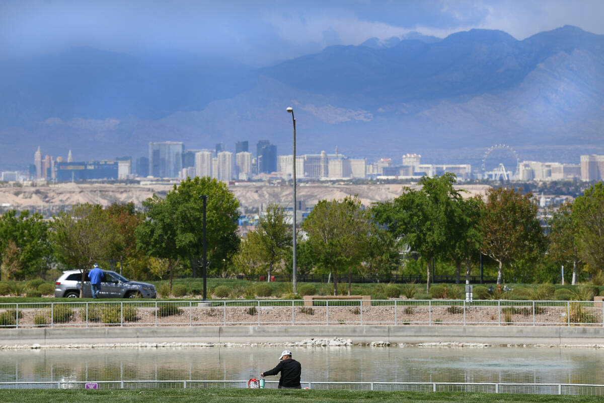 A man has lunch next to a pond in Cadence Central Park in Henderson Thursday, April 3, 2025. (S ...