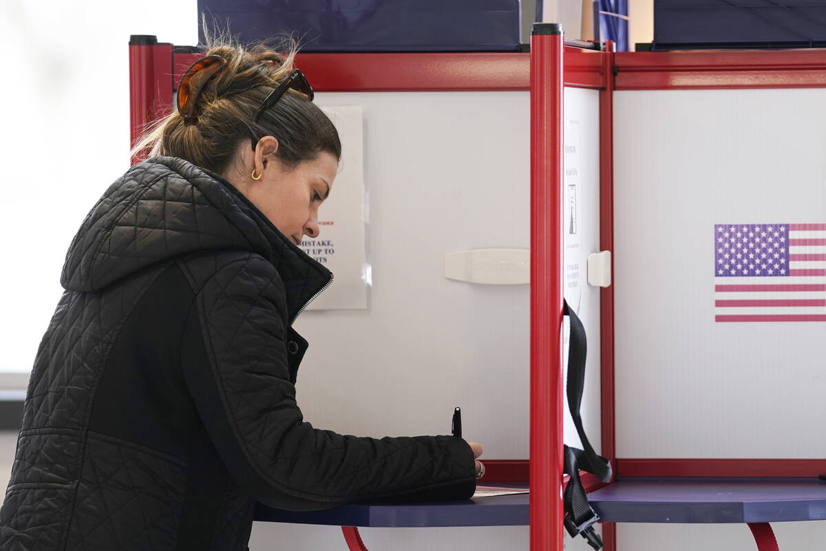 Josette Baublitz marks her ballot while voting at Waters Edge event venue in the state's Suprem ...