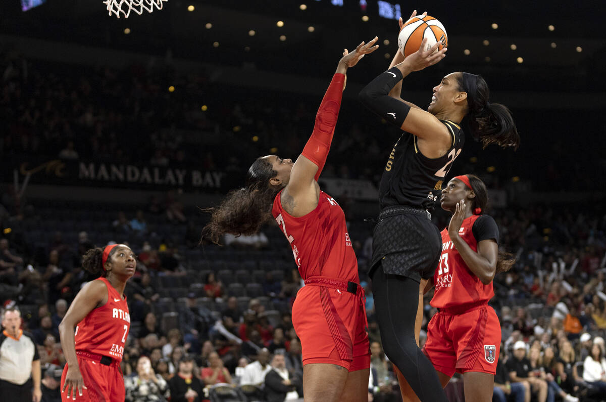 Las Vegas Aces forward A'ja Wilson (22) shoots against Atlanta Dream forward Cheyenne Parker (3 ...