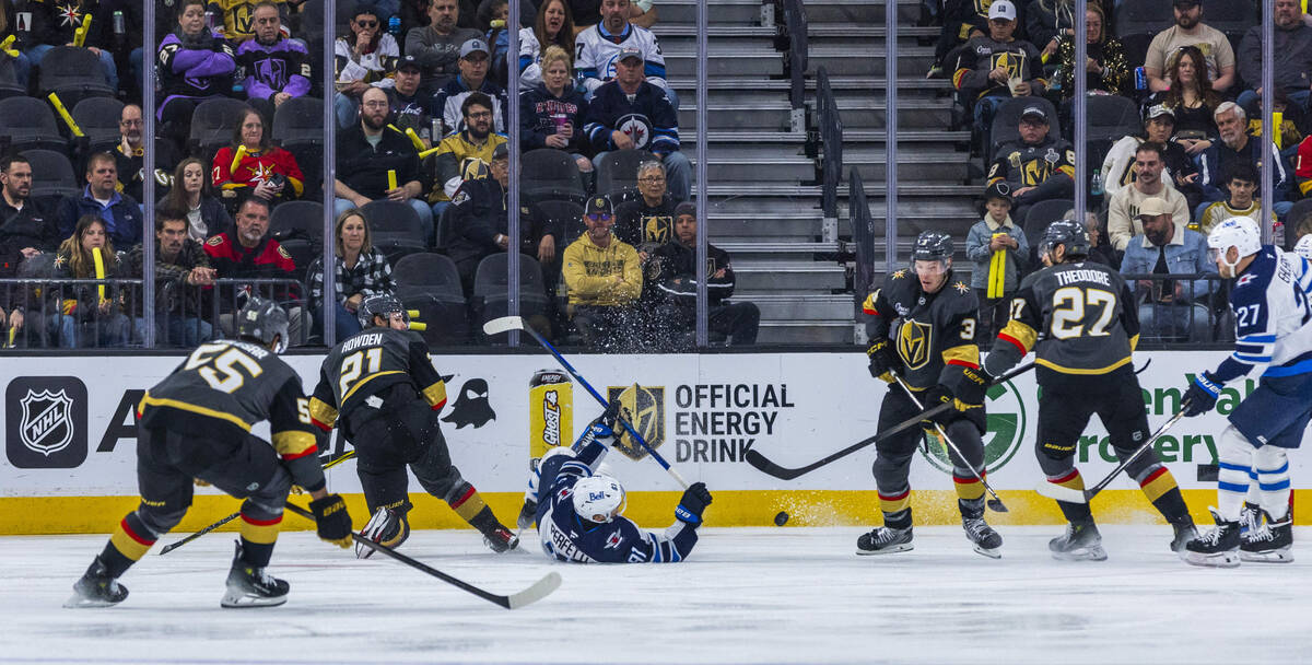 Winnipeg Jets center Cole Perfetti (91) goes to the ice after tangling with Golden Knights cent ...