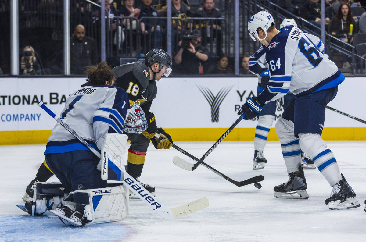 Golden Knights left wing Pavel Dorofeyev (16) looks to shoot as Winnipeg Jets goaltender Eric C ...