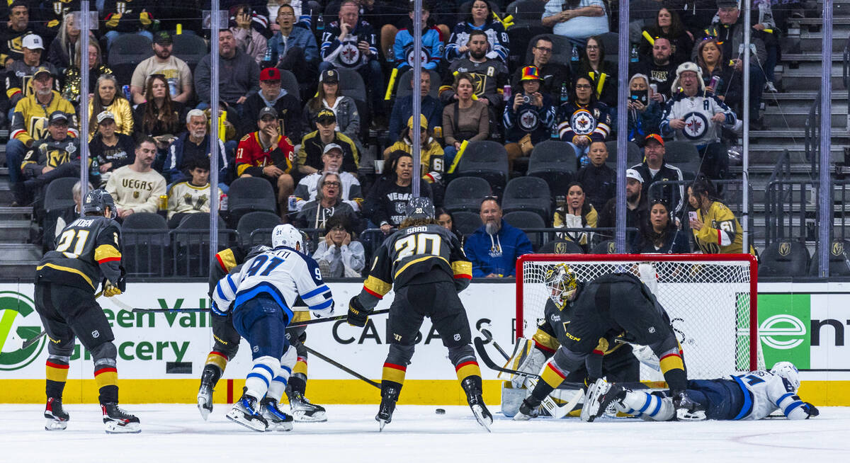 Winnipeg Jets left wing Nikolaj Ehlers (27) goes down injured as he attempted to get a shot aga ...
