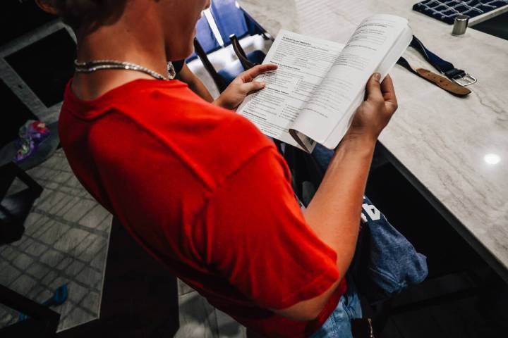 Dylan Foster, 15, looks through his grammar book Saturday, April 12, 2025, in Las Vegas. (Madel ...