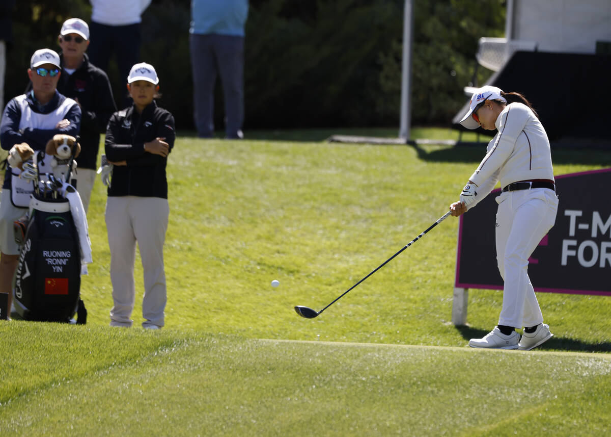 Sei Young Kim of Korea hits her tee drive as Ruoning Yin of China, left, looks on during the th ...
