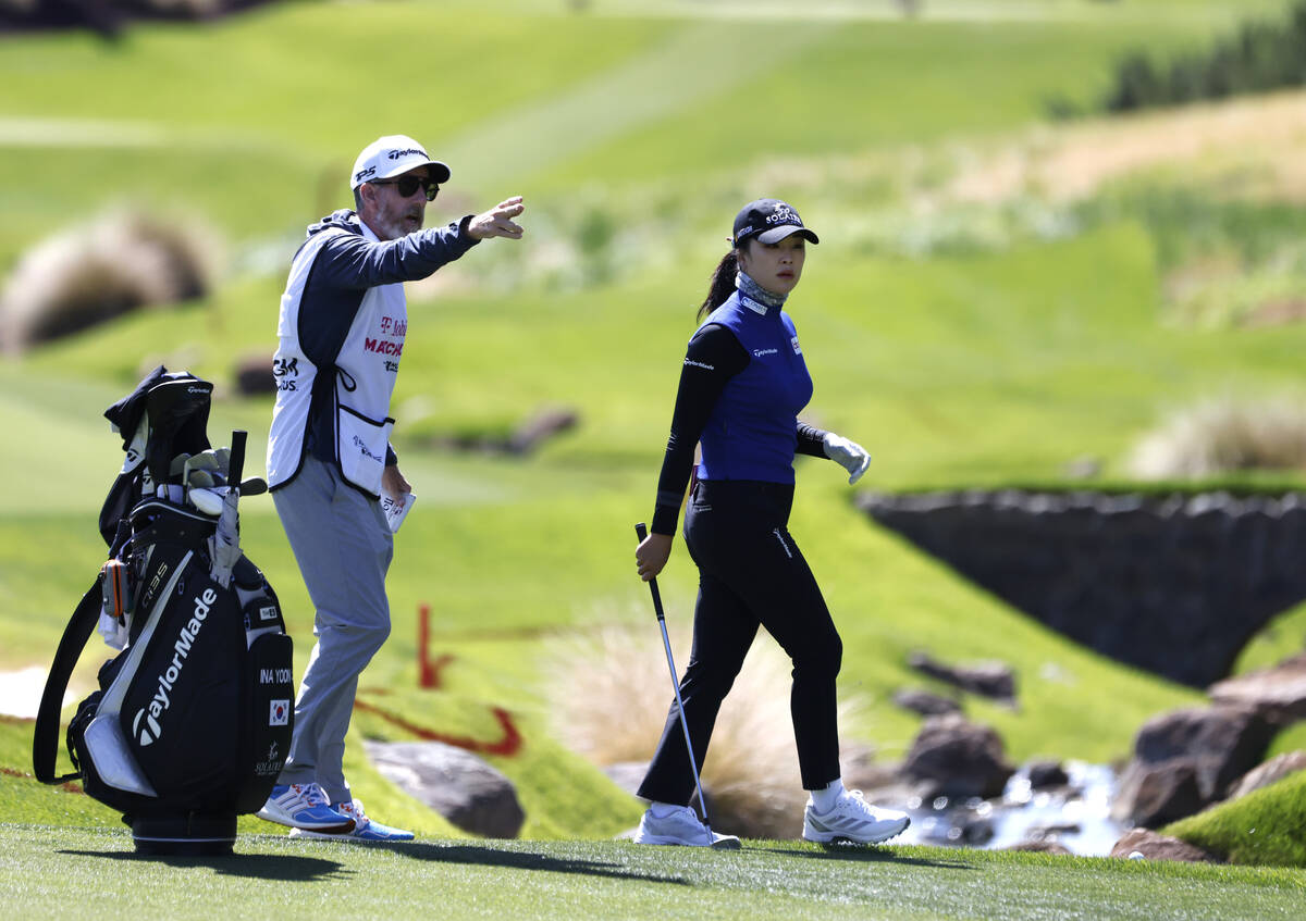 Ina Yoon of Korea gets some advice from her caddy as she prepares to hit from the fairway durin ...