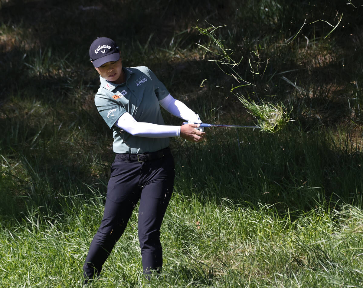Yuka Saso of Japan chips from a fairway after her tee drive came to rest on grass during the th ...
