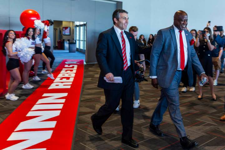 New UNLV men's basketball coach Josh Pastner walks into the room with Director of Athletics Eri ...