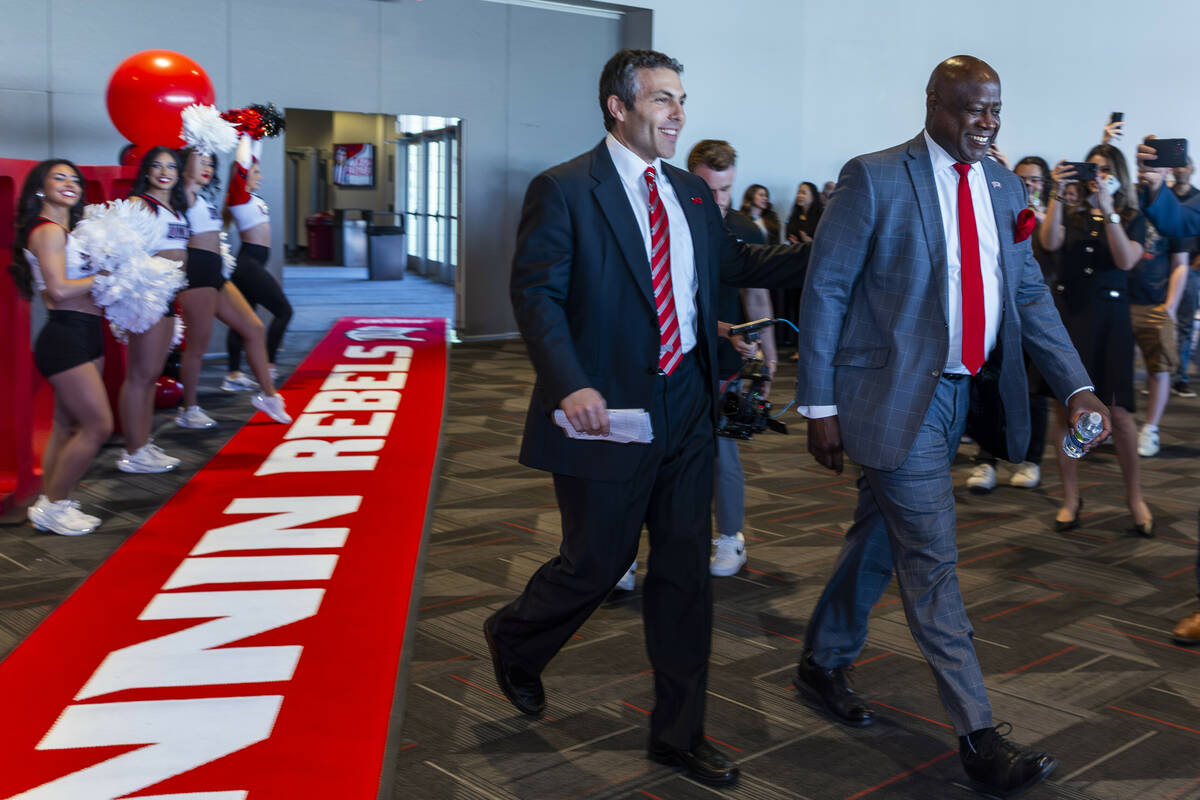 New UNLV men's basketball coach Josh Pastner walks into the room with Director of Athletics Eri ...