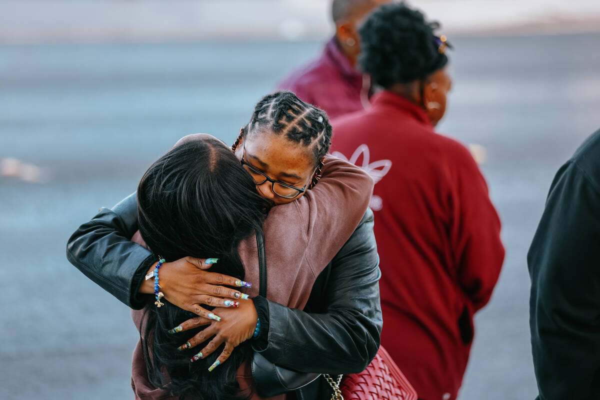 Phalan Whitson hugs an attendee to the vigil for her daughter, three-year-old Journei Ross, on ...