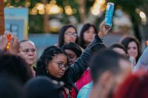 Phalan Whitson holds up a lit candle to commemorate the life of her three-year-old daughter, Jo ...