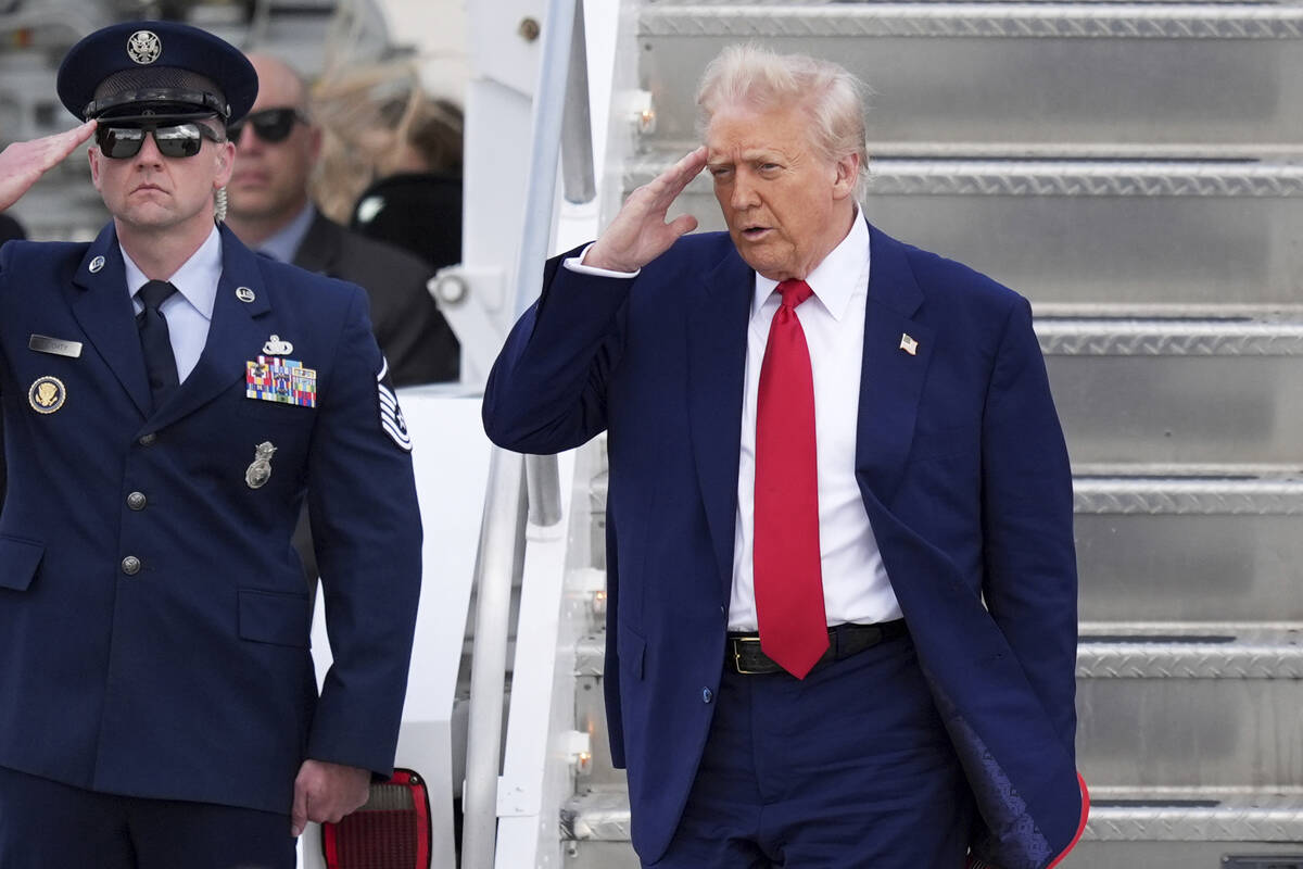 President Donald Trump, right, salutes as he arrives on Air Force One at Miami International Ai ...