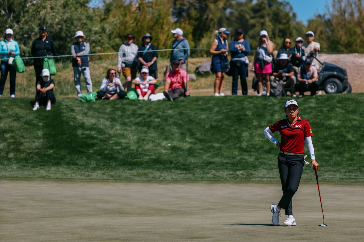 Jeeno Thitikul of Thailand watches her opponent Angel Yin on the green of the second hole durin ...