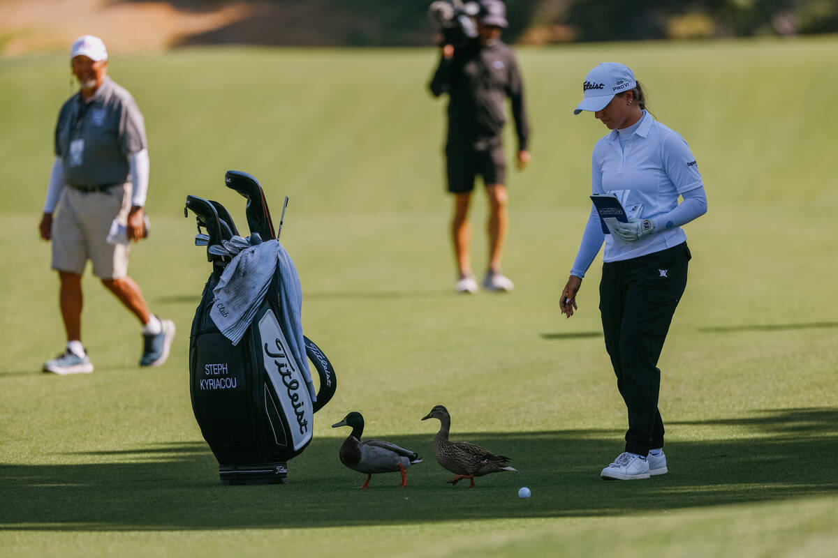 Stephanie Kyriacou of Australia waves ducks away from her position on the fairway at the ninth ...
