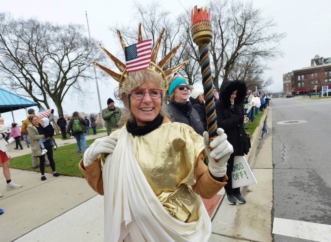 Barbara Starke joins hundreds of people gathered in downtown St. Joseph, Mich., Saturday, April ...