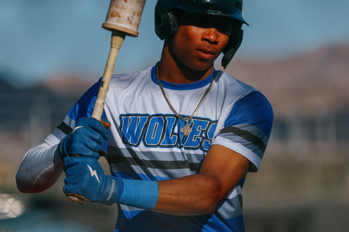 Basic batter Ace Sapp (5) warms up his swing while on deck to bat during the baseball game agai ...