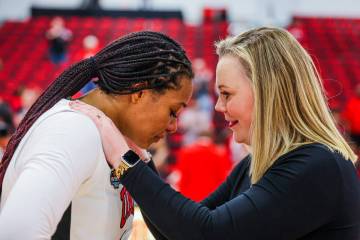 Lady Rebels head coach Lindy La Rocque comforts Lady Rebels forward Alyssa Brown following a lo ...