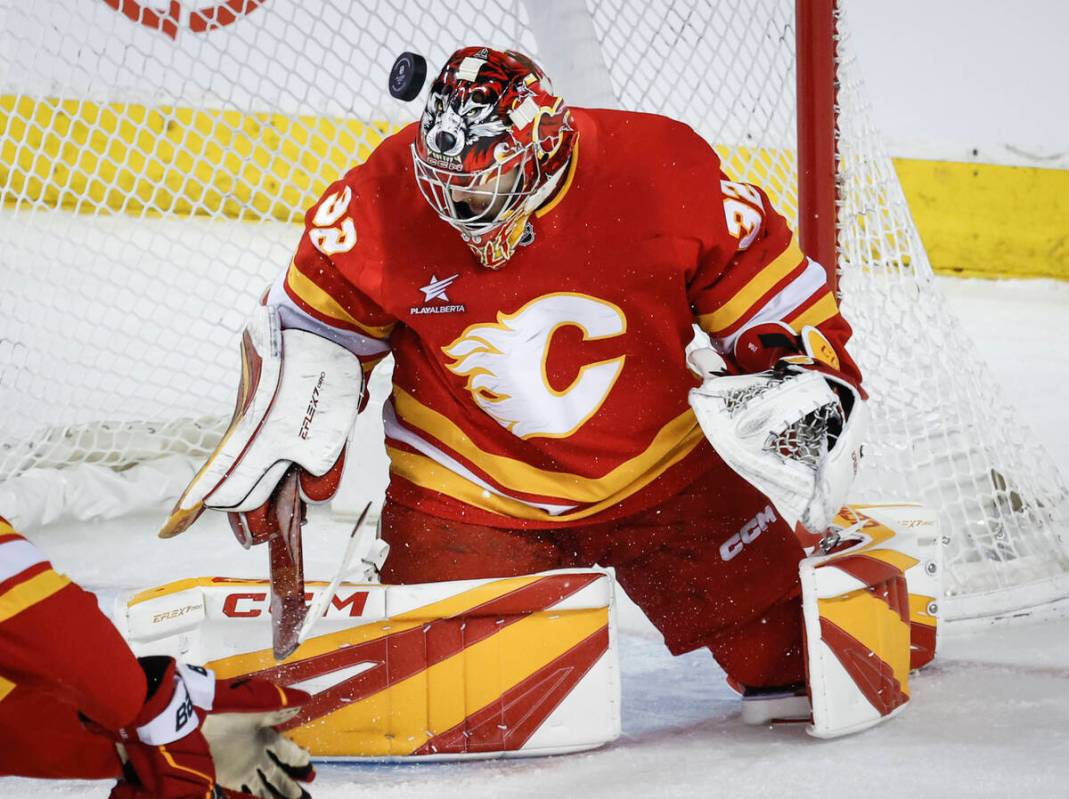 Calgary Flames goalie Dustin Wolf loses track of the puck during first period NHL hockey action ...