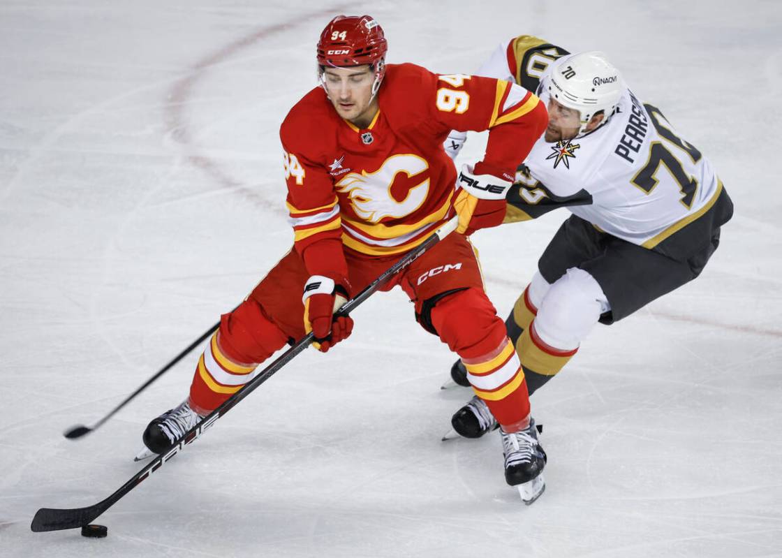 Vegas Golden Knights' Tanner Pearson, right, checks Calgary Flames' Brayden Pachal during secon ...