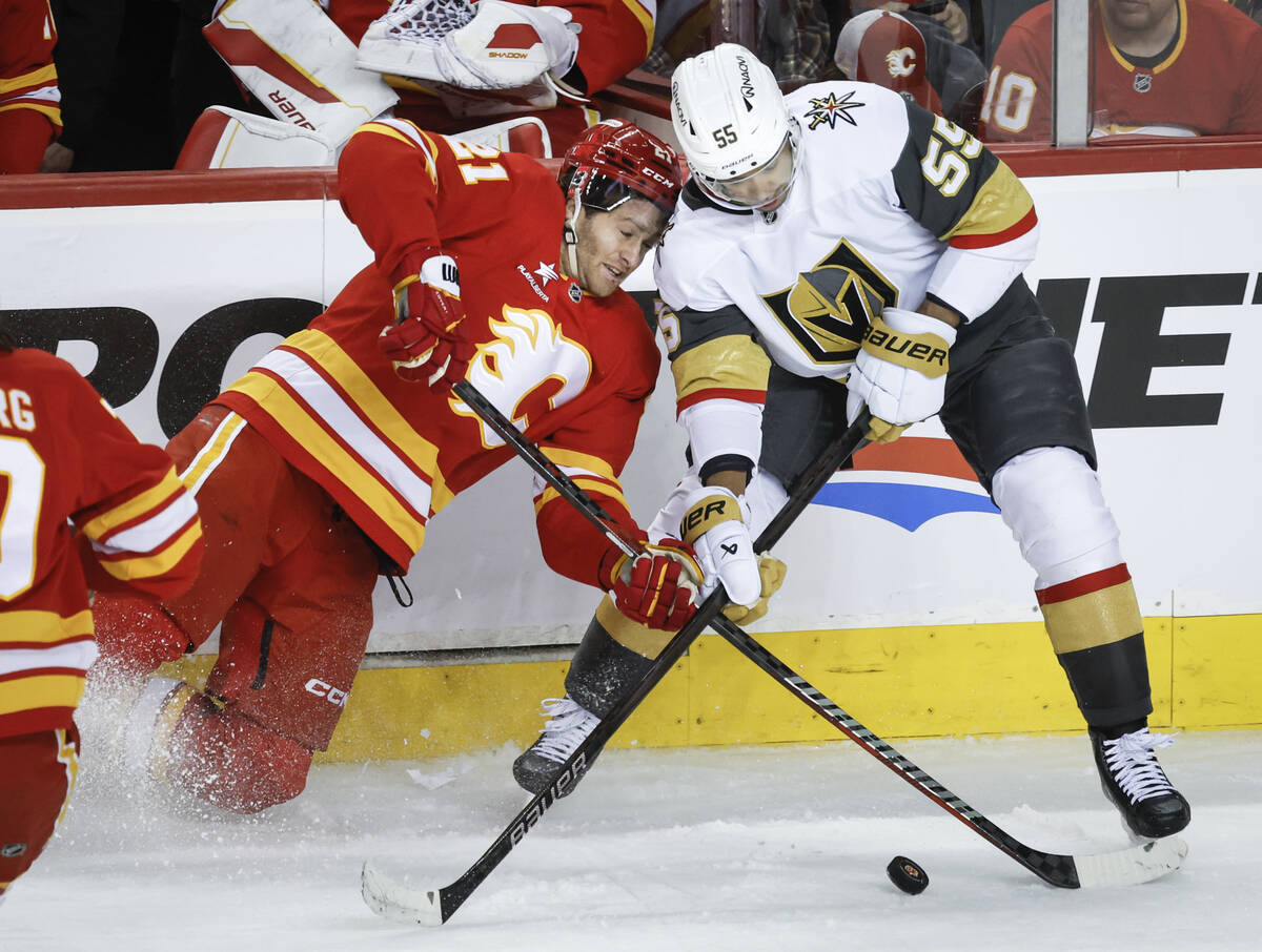Vegas Golden Knights' Keegan Kolesar, right, checks Calgary Flames' Kevin Rooney during second ...