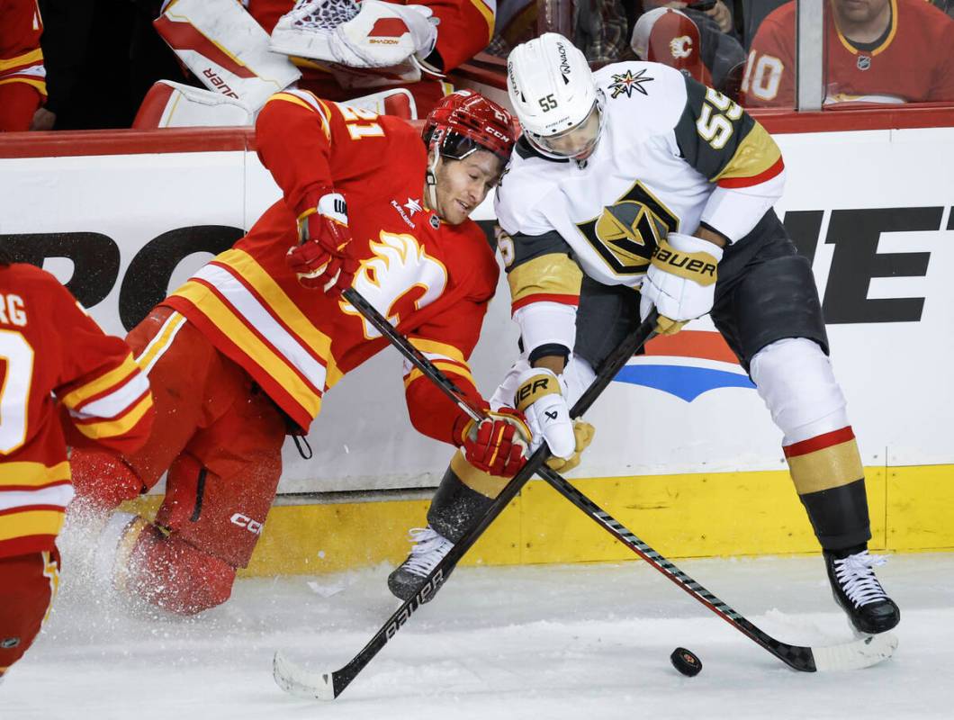 Vegas Golden Knights' Keegan Kolesar, right, checks Calgary Flames' Kevin Rooney during second ...