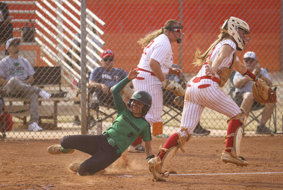 Palo Verde's Ava Cruz (5) slides into home plate to score a run during a softball game at Arbor ...