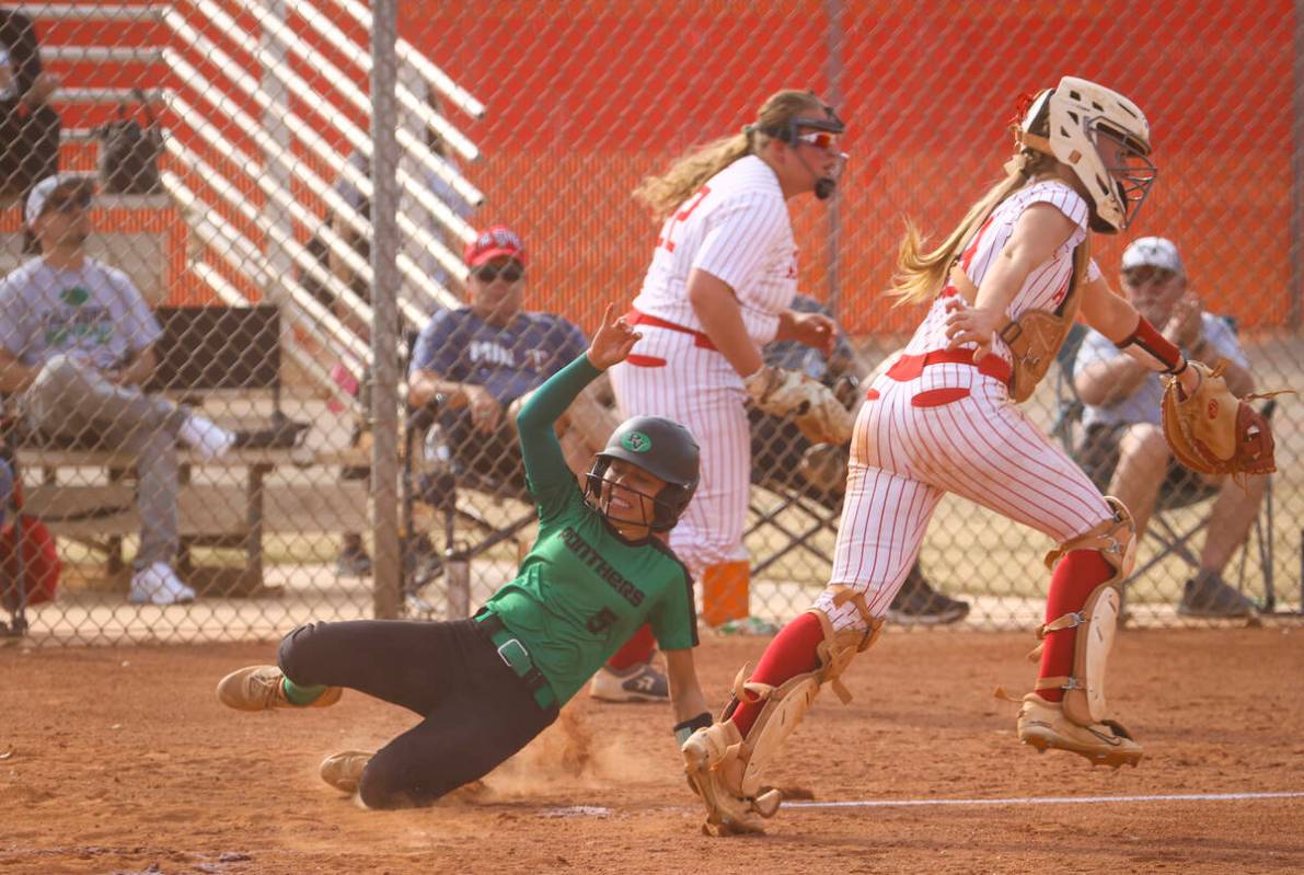 Palo Verde's Ava Cruz (5) slides into home plate to score a run during a softball game at Arbor ...