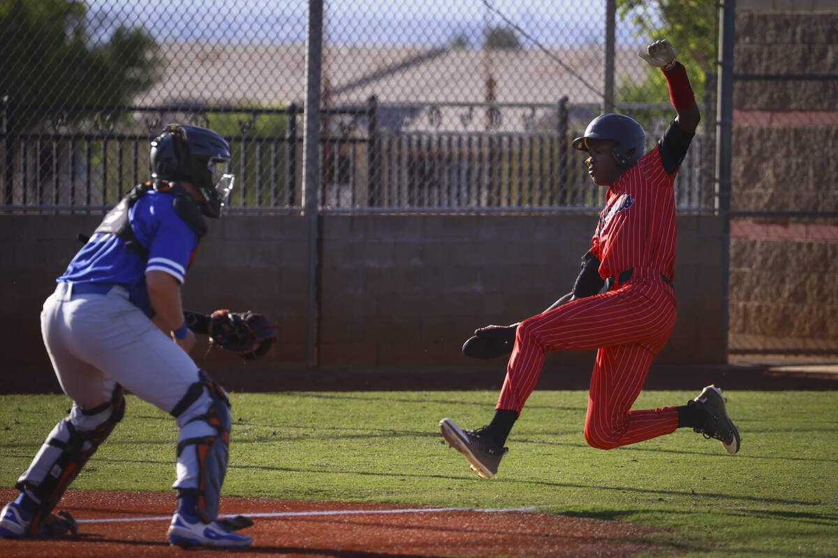 Las Vegas' Jonathon Pope, right, jumps to home plate to score a run against Bishop Gorman durin ...