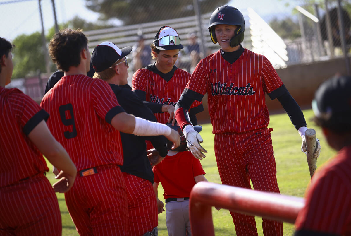 Las Vegas' Hunter Iverson, right, celebrates his run with teammates during a baseball game agai ...