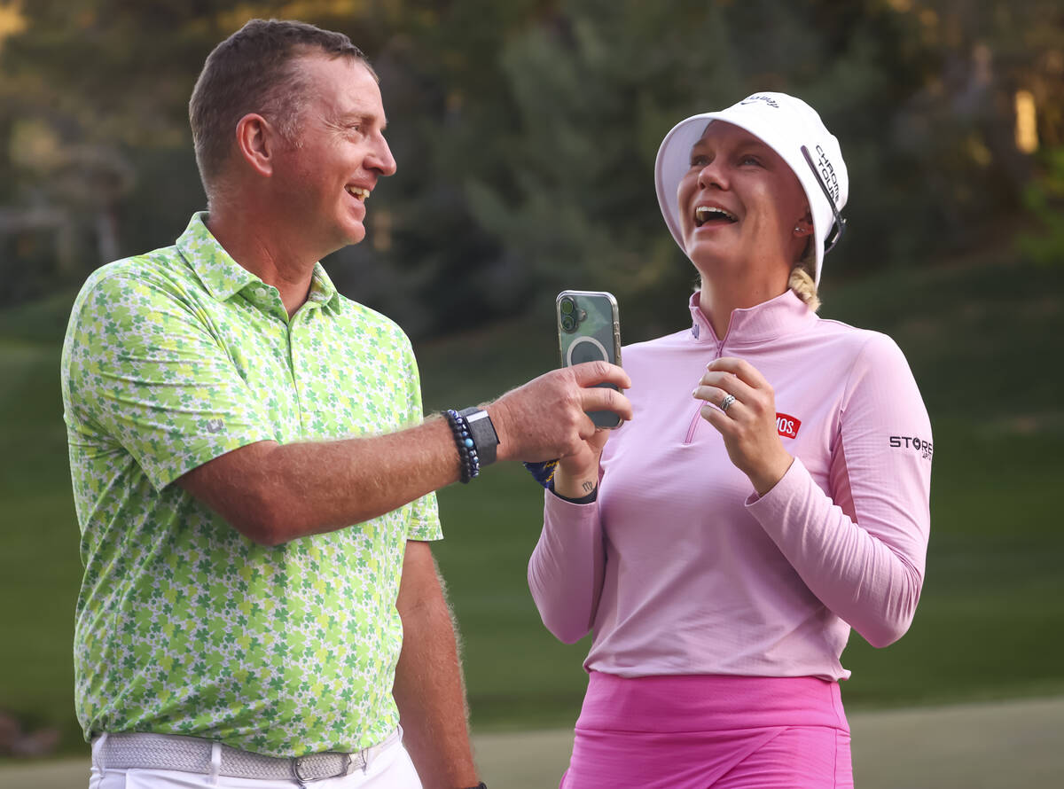 Madelene Sagstrom, right, talks to her husband over a phone held by caddie Shane Codd after win ...