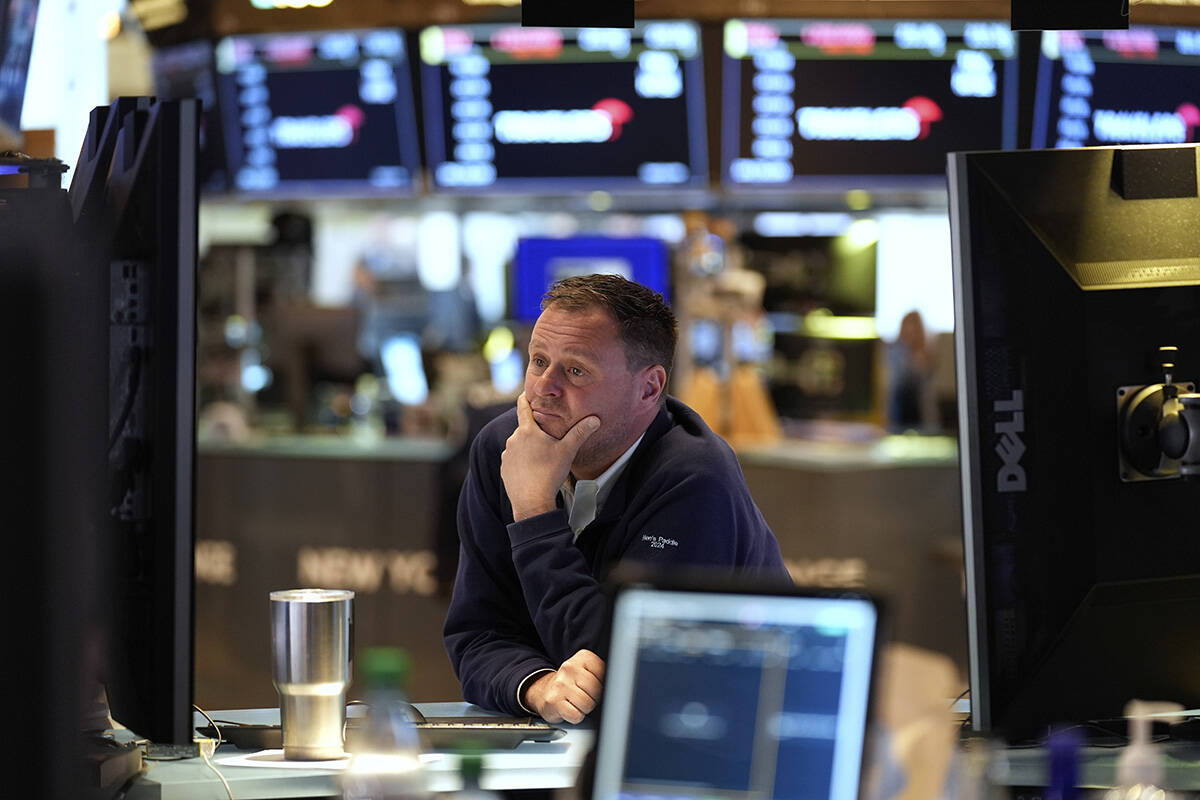 Traders work on the floor at the New York Stock Exchange in New York, Monday, April 7, 2025. (A ...