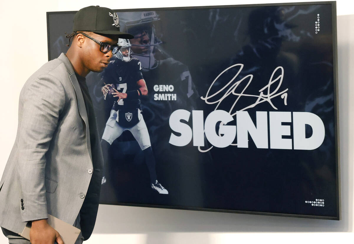 Geno Smith takes the podium to be introduced as new Raiders quarterback during a press conferen ...