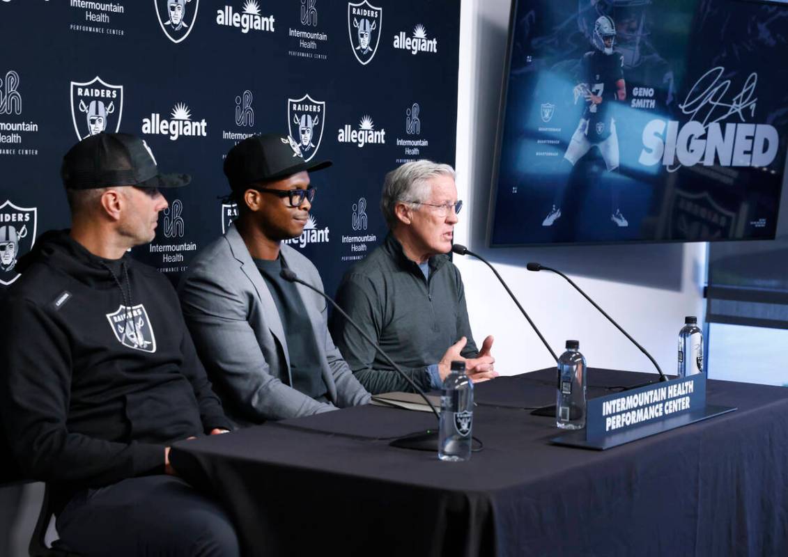Raiders head coach Pete Carroll, right, speaks as general manager John Spytek, left, and Geno S ...