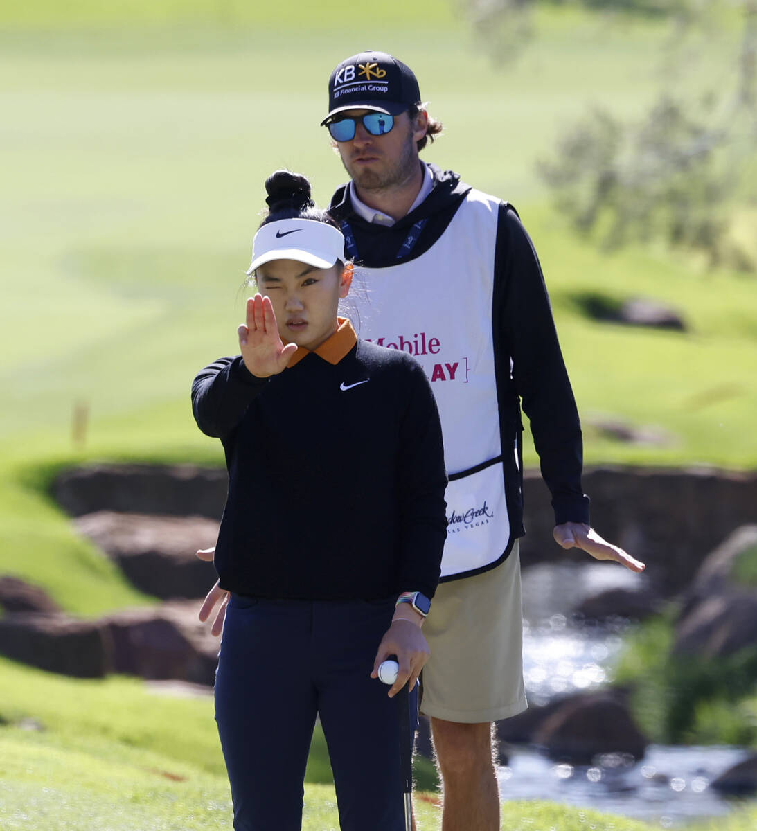 Lucy Li of the USA measures up the line of play at the second hole during the second round of t ...