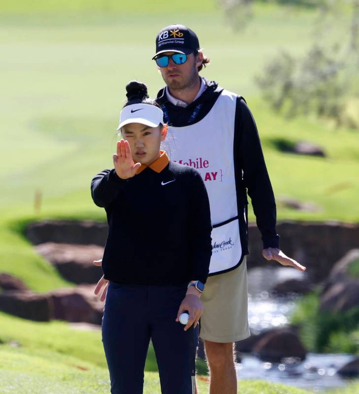 Lucy Li of the USA measures up the line of play at the second hole during the second round of t ...