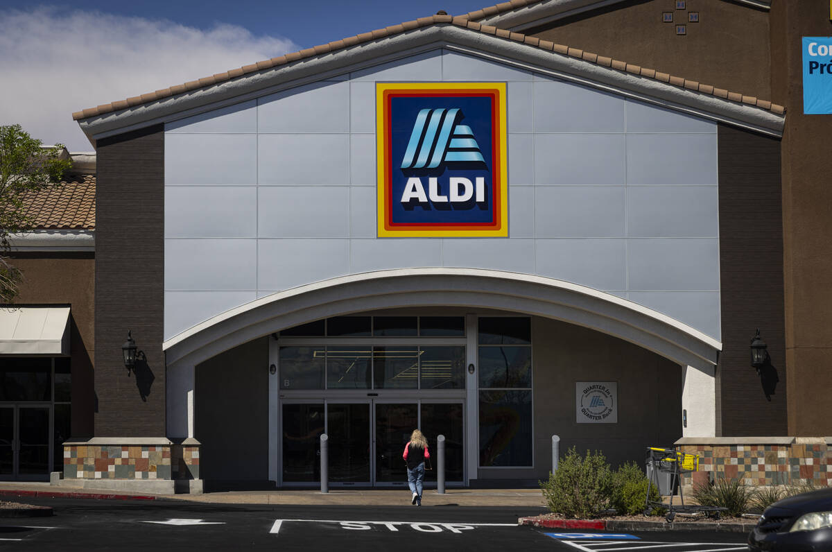A woman walks up to take a look at discount grocery store Aldi, slated to open later this month ...