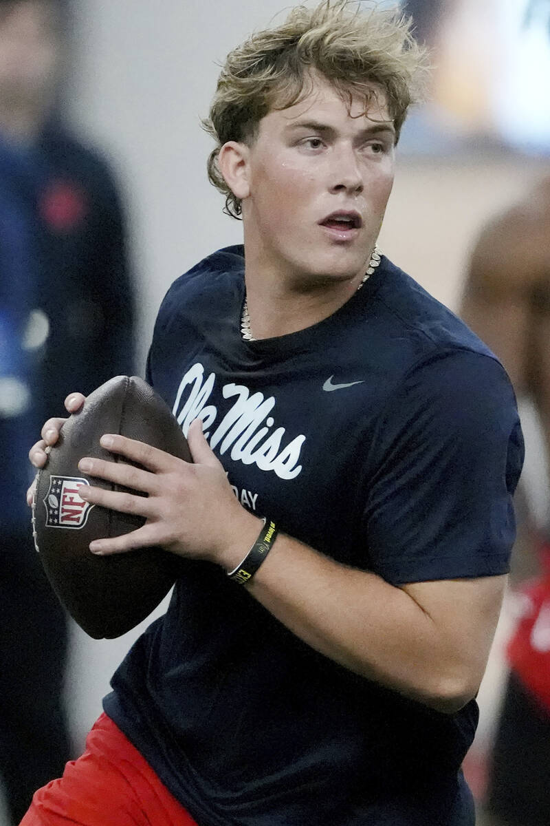 Mississippi quarterback Jaxson Dart sets up to pass during an offensive passing drill at the sc ...