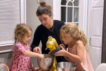 Danielle McWilliams cooks with her daughters Reese, 7, right, and Remi, 4, at their New Jersey ...