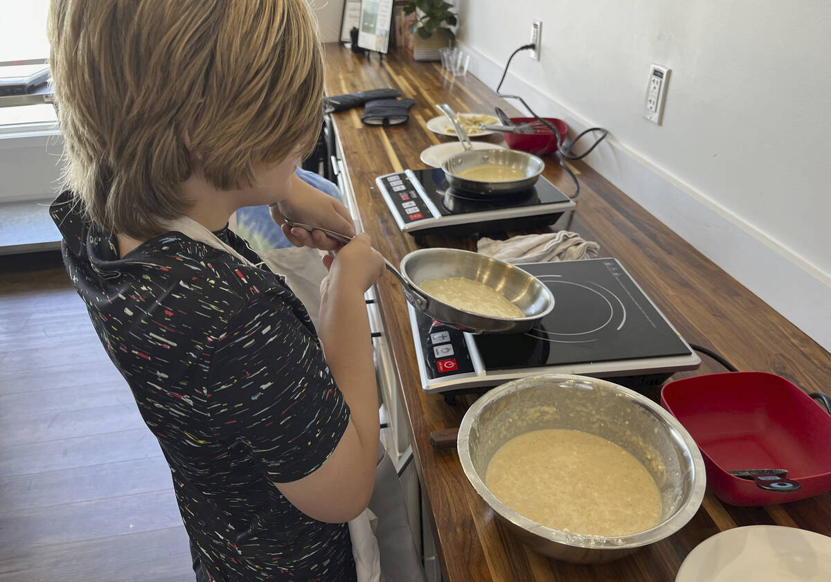This image shows a child making crepes at Third Space Kitchen, a facility offering kids cooking ...